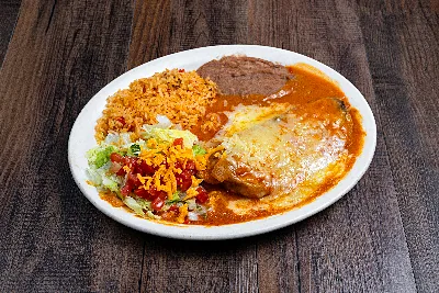 A battered chile relleno under red sauce and melted cheese, with Mexican rice, refried beans and a salad.