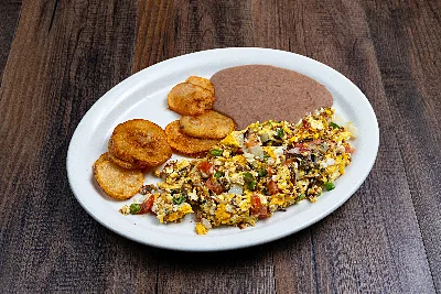 Machacado shredded beef scrambled with egg and pico de gallo, with fried potato rounds and refried beans.